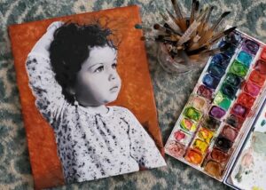 Portrait of a toddler girl in contrast black and white with Terra Cotta background, by artist Maryanne Chisholm