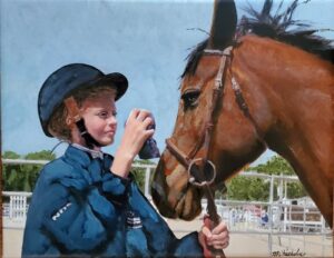Portrait of a young girl preparing to compete with her horse