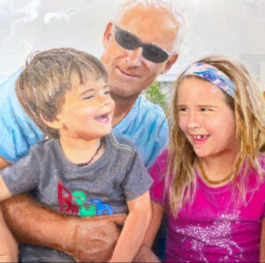 Portrait of a family laughing by Maryanne Chisholm