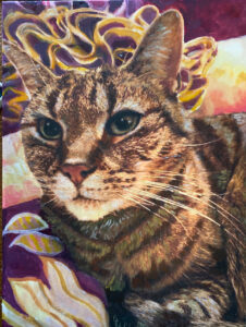 Portrait of a Tabby cat with a flower