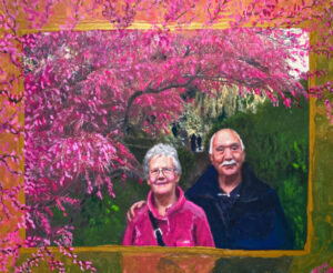 Portrait of a 50th anniversary in a lush garden with cherry blossoms by Maryanne Chisholm
