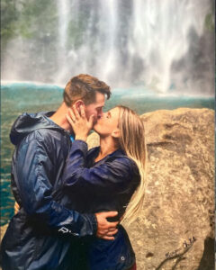 PORTRAIT OF ENGAGED COUPLE BY A WATERFALL